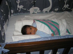 Aaron in his crib